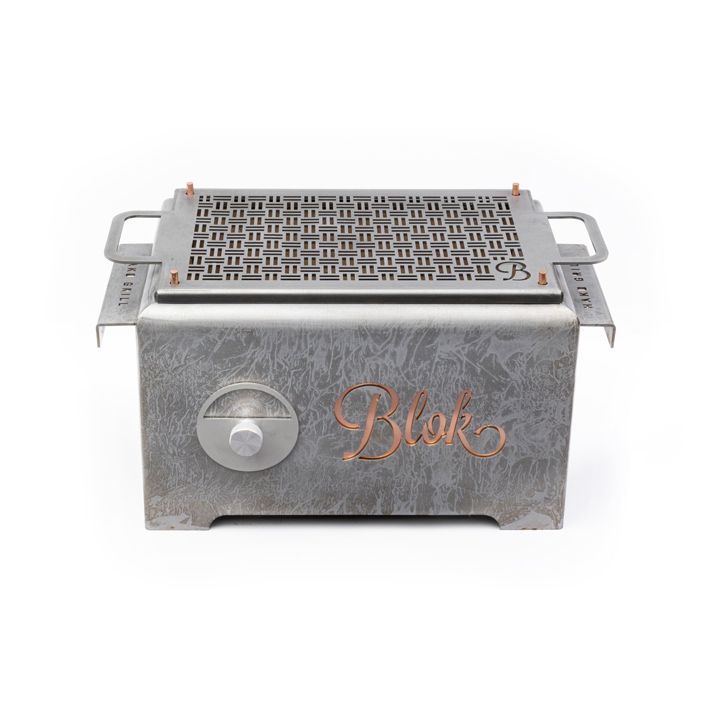 View of the Blok Hako Patina Table Grill in a backyard setting